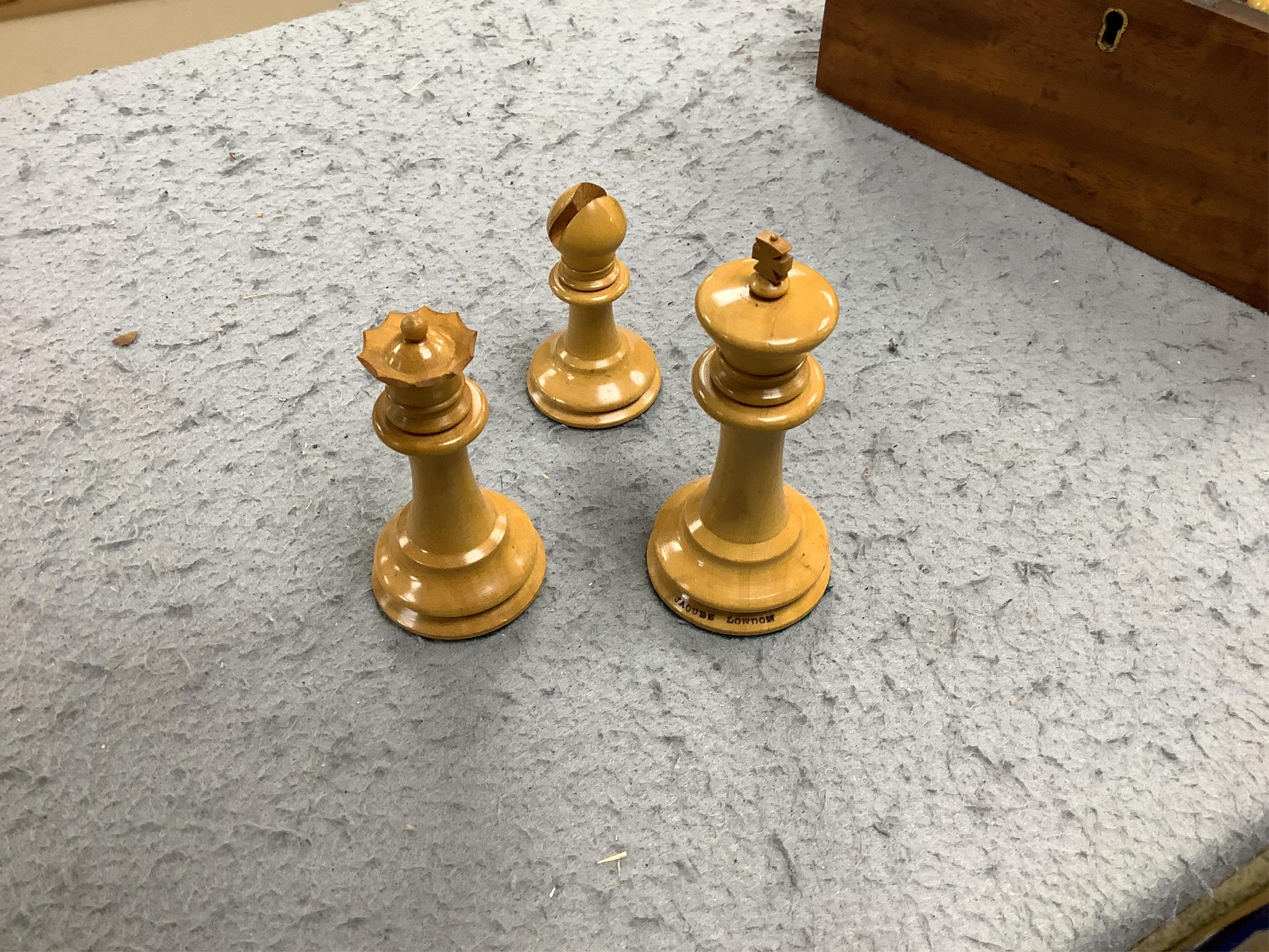 A boxed Jaques Staunton boxwood and ebonised lead weighted chess set, White king stamped Jaques London, Kings 10cm, unlabelled box 20cm wide x 9cm high. Condition - chess pieces good, box cracked